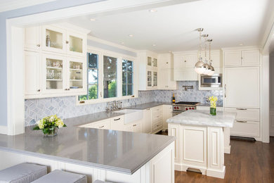 Inspiration for a timeless u-shaped kitchen remodel in Seattle with glass-front cabinets