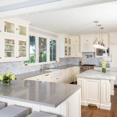 Inspiration for a timeless u-shaped kitchen remodel in Seattle with glass-front cabinets