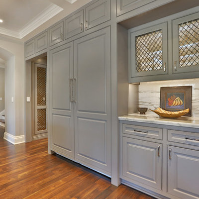 Example of a large classic u-shaped dark wood floor and brown floor eat-in kitchen design in Columbus with an undermount sink, beaded inset cabinets, gray cabinets, marble countertops, white backsplash, marble backsplash, paneled appliances, an island and white countertops
