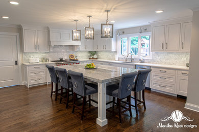 Example of a huge transitional u-shaped medium tone wood floor and brown floor open concept kitchen design in Chicago with an undermount sink, beaded inset cabinets, white cabinets, marble countertops, white backsplash, marble backsplash, stainless steel appliances, an island and gray countertops