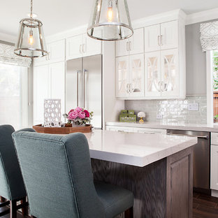 Large contemporary open plan kitchen in San Diego with an undermount sink, recessed-panel cabinets, white cabinets, quartz benchtops, grey splashback, ceramic splashback, stainless steel appliances, porcelain floors and with island.