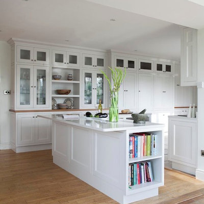 Eat-in kitchen - transitional u-shaped eat-in kitchen idea in Dublin with an undermount sink, beaded inset cabinets, white cabinets, gray backsplash, stone slab backsplash and stainless steel appliances
