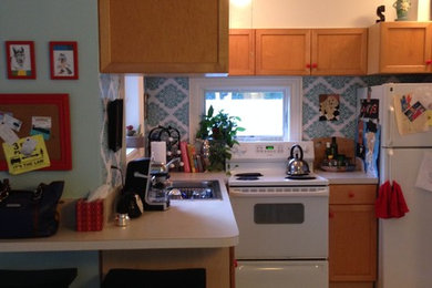 Beach style kitchen photo in Miami with laminate countertops and white appliances
