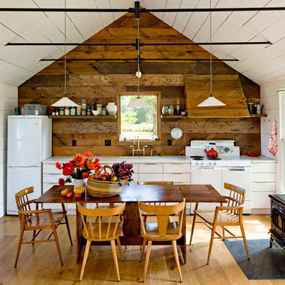 Farmhouse single-wall eat-in kitchen photo in Portland with white appliances, flat-panel cabinets and white cabinets