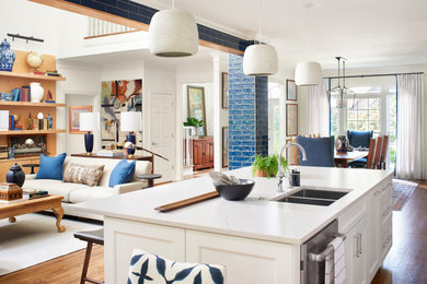 Inspiration for an eclectic u-shaped dark wood floor and brown floor eat-in kitchen remodel in Atlanta with an undermount sink, recessed-panel cabinets, white cabinets, quartz countertops, blue backsplash, subway tile backsplash, stainless steel appliances, an island and white countertops
