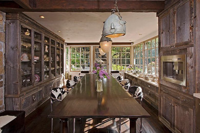 Eat-in kitchen - rustic dark wood floor eat-in kitchen idea in Los Angeles with a farmhouse sink, shaker cabinets, stone tile backsplash, stainless steel appliances and no island