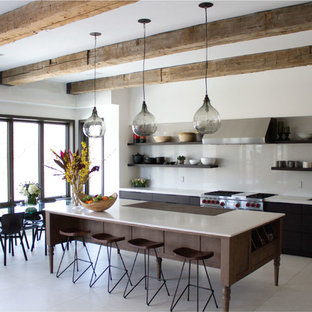 Contemporary single-wall eat-in kitchen in London with a drop-in sink, open cabinets, dark wood cabinets, grey splashback, stone slab splashback and stainless steel appliances.