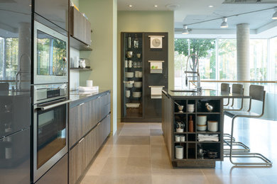 Example of a mid-sized trendy limestone floor eat-in kitchen design in Toronto with flat-panel cabinets, brown cabinets, quartz countertops, white backsplash, stainless steel appliances and an island