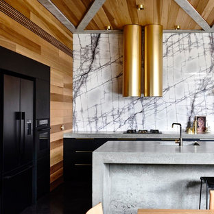 Design ideas for a contemporary eat-in kitchen in Geelong with an integrated sink, flat-panel cabinets, black cabinets, concrete benchtops, black appliances, with island and grey benchtop.