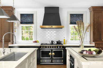Example of a transitional beige floor kitchen design in St Louis with an undermount sink, white backsplash, subway tile backsplash, black appliances, two islands, white countertops and quartzite countertops