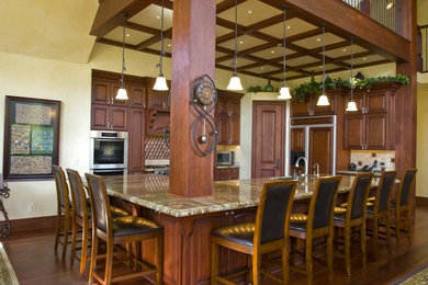 Example of a classic l-shaped dark wood floor eat-in kitchen design in Denver with an undermount sink, granite countertops, multicolored backsplash, metal backsplash, stainless steel appliances and an island
