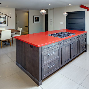 Design ideas for a large contemporary l-shaped eat-in kitchen in San Francisco with an undermount sink, recessed-panel cabinets, dark wood cabinets, quartz benchtops, stainless steel appliances, porcelain floors, with island, beige floor and red benchtop.