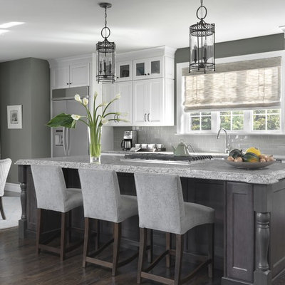Inspiration for a timeless dark wood floor and brown floor eat-in kitchen remodel in St Louis with recessed-panel cabinets, white cabinets, gray backsplash, subway tile backsplash, stainless steel appliances, an island and gray countertops