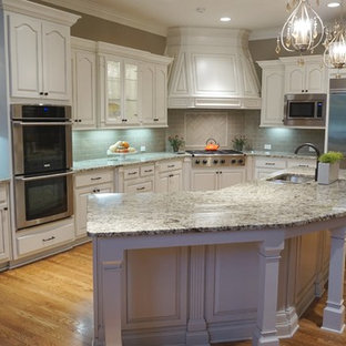Large transitional eat-in kitchen inspiration - Eat-in kitchen - large transitional u-shaped medium tone wood floor eat-in kitchen idea in Atlanta with an undermount sink, raised-panel cabinets, medium tone wood cabinets, granite countertops, gray backsplash, ceramic backsplash, stainless steel appliances and an island