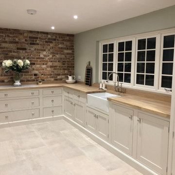 Traditional country feel cream kitchen with beaded cabinets, double oven and lar