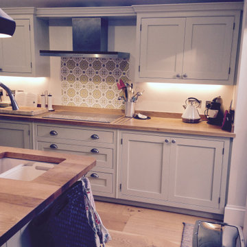 Traditional cream, handmade kitchen with wooden worktops and statement tiles