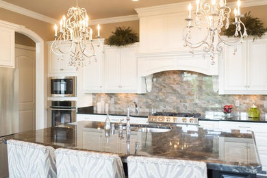 Inspiration for a mid-sized timeless kitchen remodel in Other with a double-bowl sink, raised-panel cabinets, white cabinets, marble countertops, multicolored backsplash, stone tile backsplash, paneled appliances and an island
