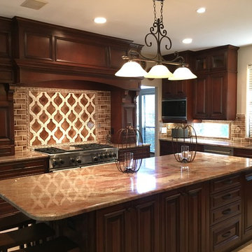 Traditional dark cherry kitchen remodel features a huge custom cherry hood