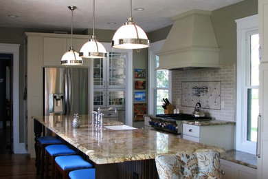 Large elegant l-shaped medium tone wood floor enclosed kitchen photo in Orlando with a farmhouse sink, recessed-panel cabinets, white cabinets, beige backsplash, stainless steel appliances, an island, granite countertops and ceramic backsplash