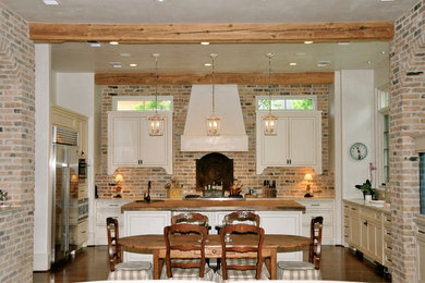 Inspiration for a classic kitchen in Houston with dark hardwood flooring and an island.