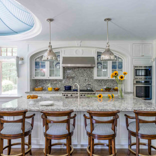 Traditional eat-in kitchen designs - Eat-in kitchen - traditional u-shaped eat-in kitchen idea in Boston with raised-panel cabinets, white cabinets and an island