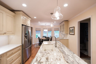 Kitchen - medium tone wood floor kitchen idea in Other with white cabinets, stainless steel appliances and an island