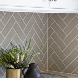 Design ideas for a mid-sized traditional u-shaped eat-in kitchen in San Francisco with an undermount sink, shaker cabinets, white cabinets, marble benchtops, grey splashback, ceramic splashback, stainless steel appliances, ceramic floors, with island, black floor and grey benchtop.