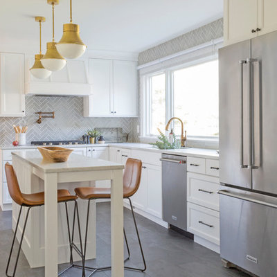 Inspiration for a mid-sized transitional l-shaped ceramic tile and gray floor kitchen remodel in Newark with an undermount sink, shaker cabinets, white cabinets, marble countertops, gray backsplash, ceramic backsplash, stainless steel appliances, an island and gray countertops