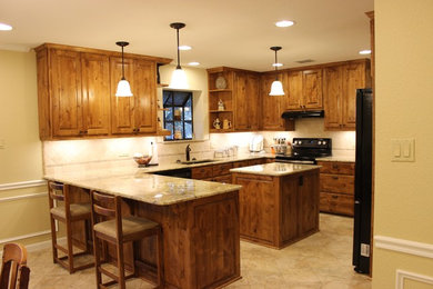 Kitchen - traditional kitchen idea with raised-panel cabinets and granite countertops