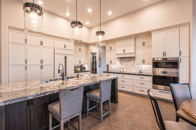 Inspiration for a large transitional l-shaped porcelain tile and beige floor open concept kitchen remodel in Phoenix with a double-bowl sink, recessed-panel cabinets, white cabinets, marble countertops, multicolored backsplash, porcelain backsplash, paneled appliances, an island and multicolored countertops