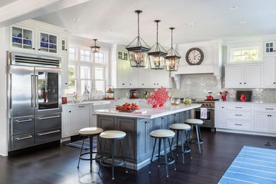 Open concept kitchen - mid-sized coastal l-shaped dark wood floor open concept kitchen idea in Providence with a farmhouse sink, shaker cabinets, white cabinets, quartzite countertops, gray backsplash, subway tile backsplash, stainless steel appliances and an island