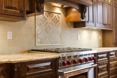 Example of a large classic l-shaped medium tone wood floor eat-in kitchen design in Vancouver with an undermount sink, raised-panel cabinets, medium tone wood cabinets, granite countertops, beige backsplash, porcelain backsplash, paneled appliances and an island