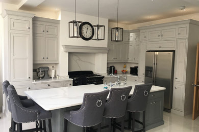 Inspiration for a large traditional l-shaped kitchen/diner in Cheshire with a belfast sink, shaker cabinets, engineered quartz splashback, ceramic flooring and an island.
