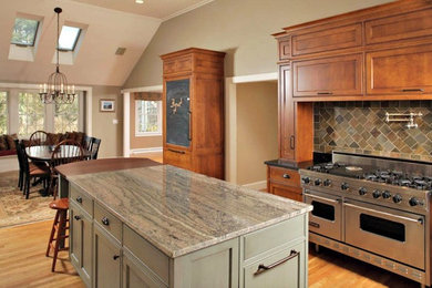 Mid-sized elegant l-shaped light wood floor kitchen photo in Boston with shaker cabinets, medium tone wood cabinets, granite countertops, slate backsplash and an island