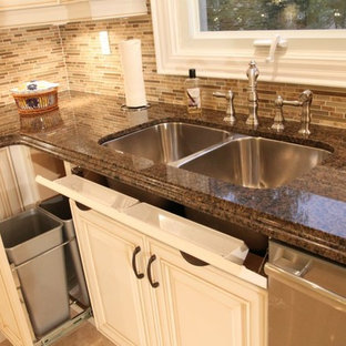 Photo of a mid-sized traditional u-shaped eat-in kitchen in Toronto with a double-bowl sink, quartz benchtops, brown splashback, ceramic splashback, stainless steel appliances, porcelain floors, no island, yellow floor, white cabinets and raised-panel cabinets.