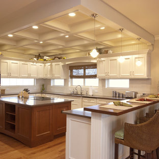Traditional kitchen ideas - Elegant kitchen photo in New York with recessed-panel cabinets, white cabinets, white backsplash and stainless steel appliances