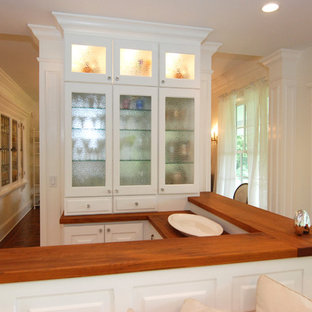 Traditional kitchen appliance - Elegant kitchen photo in New York with wood countertops