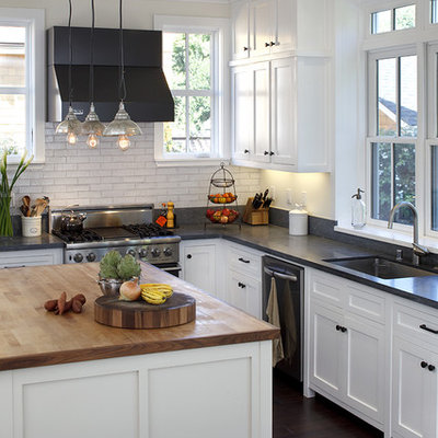 Elegant kitchen photo in San Francisco with stainless steel appliances, subway tile backsplash, wood countertops and white cabinets