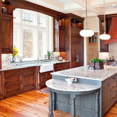 Kitchen - traditional l-shaped kitchen idea in Charleston with paneled appliances, a farmhouse sink, raised-panel cabinets, dark wood cabinets, multicolored backsplash and mosaic tile backsplash