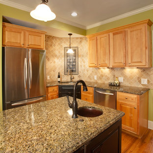 Small elegant u-shaped medium tone wood floor eat-in kitchen photo in Other with an undermount sink, raised-panel cabinets, granite countertops, beige backsplash, stone tile backsplash and an island