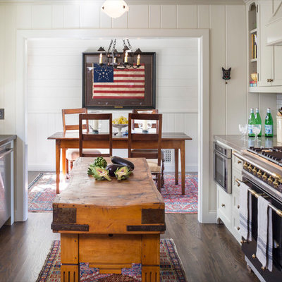 Elegant galley dark wood floor eat-in kitchen photo in Orange County with an undermount sink, shaker cabinets, limestone countertops, white backsplash, subway tile backsplash, stainless steel appliances, an island and white cabinets