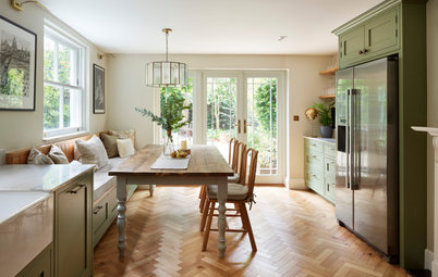 Sunlight Streams Into an Elegant Green-and-Wood Kitchen