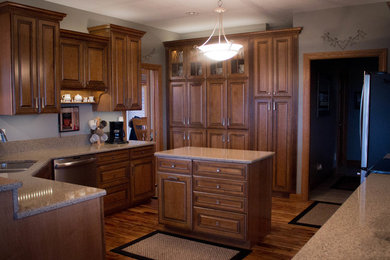 Elegant kitchen photo in Chicago with raised-panel cabinets and dark wood cabinets