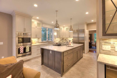 Inspiration for a traditional kitchen in Other with white cabinets, stainless steel appliances and an island.