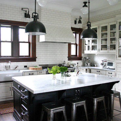 Kitchen - traditional kitchen idea in Chicago with glass-front cabinets, stainless steel appliances, a farmhouse sink, marble countertops, white backsplash, subway tile backsplash and white countertops