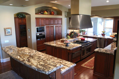 Example of a classic kitchen design in Las Vegas with stainless steel appliances and two islands