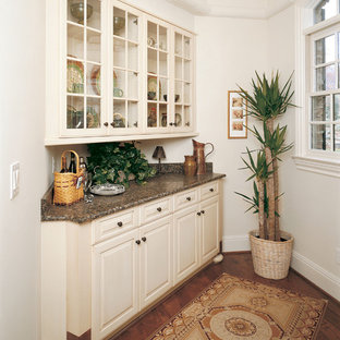 Inspiration for a traditional kitchen in Other with glass-front cabinets and beige cabinets.