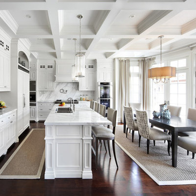 Eat-in kitchen - traditional eat-in kitchen idea in Dallas with a double-bowl sink, raised-panel cabinets, white cabinets, white backsplash and paneled appliances