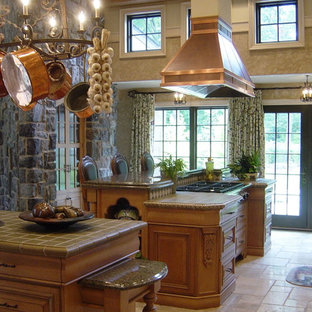 Large traditional enclosed kitchen designs - Example of a large classic enclosed kitchen design in New York with raised-panel cabinets, medium tone wood cabinets, tile countertops, stainless steel appliances, a farmhouse sink and green backsplash