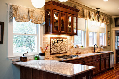 Mid-sized transitional l-shaped medium tone wood floor eat-in kitchen photo in Charlotte with an undermount sink, recessed-panel cabinets, dark wood cabinets, granite countertops, beige backsplash, subway tile backsplash and stainless steel appliances